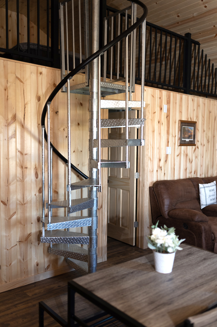 Restful Refuge cabin stairs to loft and couch by Devils Lake, North Dakota