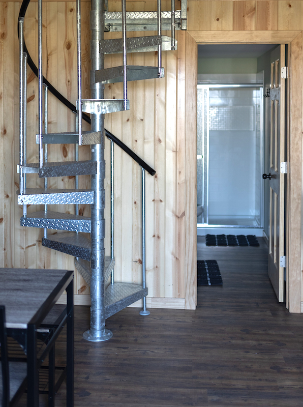 Restful Refuge cabin stairs to loft and door to bathroom by Devils Lake, North Dakota