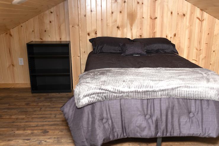 Restful Refuge cabin double bed in loft by Devils Lake, North Dakota