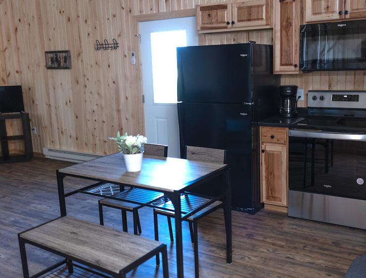 Restful Refuge cabin kitchen and dining area by Devils Lake, North Dakota
