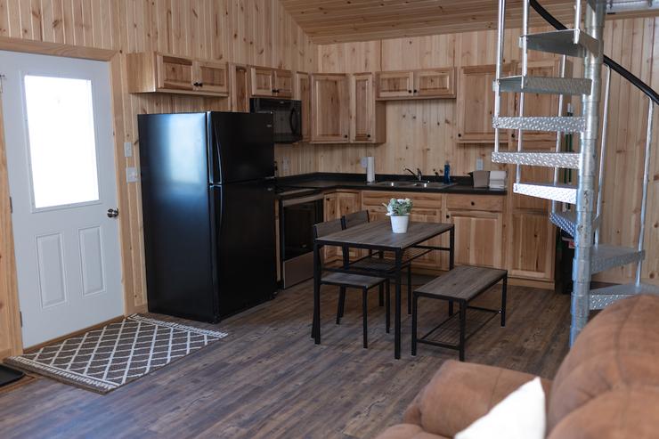 Restful Refuge cabin kitchen, dining area, stairs by Devils Lake, North Dakota